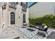 Outdoor patio featuring stylish seating, a geometric rug, and a well-maintained garden at 3117 W Knights Ave, Tampa, FL 33611