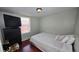 Simple bedroom with a laminate floor, TV, and large window providing natural light at 342 N 40Th N St, St Petersburg, FL 33713