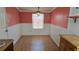 Cozy dining room featuring wainscotting, a charming chandelier, and wood-look floors at 342 N 40Th N St, St Petersburg, FL 33713
