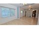 Bright living area showcasing large windows, laminate flooring, and an open flow to the kitchen at 342 N 40Th N St, St Petersburg, FL 33713