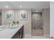Modern bathroom with a glass bowl sink, artwork, and a glass enclosed shower at 350 Pinellas Bayway S # 7, Tierra Verde, FL 33715
