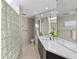 Modern bathroom boasts a glass block shower and a sleek vanity with a large mirror at 350 Pinellas Bayway S # 7, Tierra Verde, FL 33715