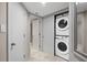 Convenient laundry area featuring a stacked washer and dryer and hallway access at 350 Pinellas Bayway S # 7, Tierra Verde, FL 33715
