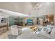 Open-concept living room with vaulted ceilings, a spiral staircase, and views into the dining area at 350 Pinellas Bayway S # 7, Tierra Verde, FL 33715