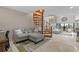 Cozy living room with a spiral staircase leading to the upper level and views of the outdoor patio at 350 Pinellas Bayway S # 7, Tierra Verde, FL 33715