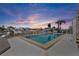 Outdoor pool area with a patio, palm trees, and waterfront views at 350 Pinellas Bayway S # 7, Tierra Verde, FL 33715
