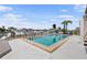 Outdoor pool area with a patio, palm trees, and waterfront views at 350 Pinellas Bayway S # 7, Tierra Verde, FL 33715
