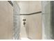 Elegant bathroom featuring a glass block shower, neutral toned tile, and modern fixtures at 350 Pinellas Bayway S # 7, Tierra Verde, FL 33715