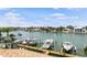 Scenic waterfront view with multiple boats docked along the canal, palm trees, and waterfront homes at 350 Pinellas Bayway S # 7, Tierra Verde, FL 33715