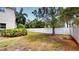 A well maintained backyard with a healthy lawn and a sturdy white fence at 3615 S Church Ave, Tampa, FL 33629