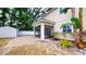 Exterior shot of a paved backyard featuring a screened-in porch and storage shed at 3615 S Church Ave, Tampa, FL 33629