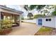 A view of the backyard with a paved patio, storage shed, and white fence at 3615 S Church Ave, Tampa, FL 33629