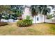 A view of the backyard and exterior of the home featuring lush tropical landscaping at 3615 S Church Ave, Tampa, FL 33629