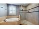 Bright bathroom featuring a standalone tub and a tiled glass shower at 3615 S Church Ave, Tampa, FL 33629