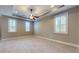 Main bedroom features plush carpet, recessed lighting, tray ceiling, and many bright windows at 3615 S Church Ave, Tampa, FL 33629