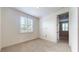 This bedroom features neutral-colored walls and carpet plus a large window with white shutters at 3615 S Church Ave, Tampa, FL 33629