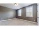 Cozy bedroom featuring neutral gray walls and bright natural light from shuttered windows at 3615 S Church Ave, Tampa, FL 33629