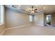 Spacious main bedroom boasts soft carpet, recessed lighting, decorative tray ceiling, and natural light at 3615 S Church Ave, Tampa, FL 33629