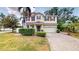 Inviting two-story home with a well-manicured lawn, mature landscaping, and a paver driveway at 3615 S Church Ave, Tampa, FL 33629