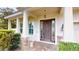 Elegant entryway with a wooden front door framed by stone pillars and lush greenery at 3615 S Church Ave, Tampa, FL 33629