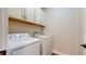 Convenient laundry room features a washer, a dryer, and cabinet storage above at 3615 S Church Ave, Tampa, FL 33629