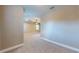View of the spacious main bedroom featuring neutral carpeting, a tray ceiling, and bright windows at 3615 S Church Ave, Tampa, FL 33629