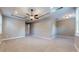 Spacious main bedroom featuring tray ceilings, carpet flooring, and an ensuite bathroom at 3615 S Church Ave, Tampa, FL 33629