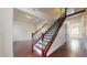 Elegant staircase with wood and iron detailing, complemented by hardwood flooring throughout at 3615 S Church Ave, Tampa, FL 33629