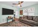 Cozy living room with a plush couch, TV, windows, and colorful area rug on wood floor at 3621 18Th N St, St Petersburg, FL 33713
