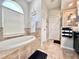 Bright bathroom features a soaking tub, lots of natural light, and a shower with a glass door at 408 Delwood Breck St, Ruskin, FL 33570