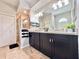 Bathroom featuring a shower with glass door, double vanity, and neutral tile floors at 408 Delwood Breck St, Ruskin, FL 33570