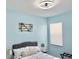 Stylish bedroom featuring blue walls, nautical decor, and natural textures at 408 Delwood Breck St, Ruskin, FL 33570