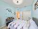 Stylish bedroom featuring blue walls, nautical decor, storage closet, and natural textures at 408 Delwood Breck St, Ruskin, FL 33570