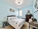 Stylish bedroom featuring blue walls, nautical decor, and natural textures at 408 Delwood Breck St, Ruskin, FL 33570