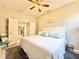 Bright bedroom featuring a king-size bed, ceiling fan, and doorway to other parts of the house at 408 Delwood Breck St, Ruskin, FL 33570