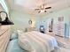 Lovely bedroom with a ceiling fan, lots of natural light, a dresser, and an armchair with footstool at 408 Delwood Breck St, Ruskin, FL 33570