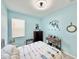 Stylish bedroom featuring blue walls, nautical decor, and natural textures at 408 Delwood Breck St, Ruskin, FL 33570