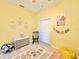 Bright room featuring yellow walls, playful decor and an alphabet rug at 408 Delwood Breck St, Ruskin, FL 33570