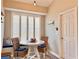 Bright dining nook with a white table, rattan chairs, and plantation shutters for a cozy breakfast area at 408 Delwood Breck St, Ruskin, FL 33570
