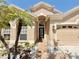 Home front exterior featuring a well-maintained lawn, black front door, and two-car garage at 408 Delwood Breck St, Ruskin, FL 33570