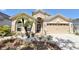 Beautiful tan home exterior featuring a well-maintained lawn, front door, and two-car garage at 408 Delwood Breck St, Ruskin, FL 33570