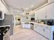 Open kitchen with stainless steel appliances, modern cabinetry, and breakfast bar, creating a perfect cooking space at 408 Delwood Breck St, Ruskin, FL 33570