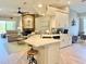 Bright kitchen with island, stone countertops, stainless appliances, and fireplace adjacent to comfortable seating at 408 Delwood Breck St, Ruskin, FL 33570
