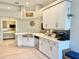 Well-lit kitchen with stainless steel appliances, white cabinetry, and breakfast bar, blending style and functionality at 408 Delwood Breck St, Ruskin, FL 33570