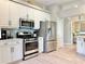 Well-equipped kitchen with stainless steel appliances, white cabinets, and modern fixtures at 408 Delwood Breck St, Ruskin, FL 33570