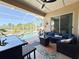Screened lanai features comfortable seating, ceiling fan, and views of the pool at 408 Delwood Breck St, Ruskin, FL 33570