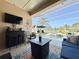 Screened lanai with a full bar setup next to the covered patio seating area at 408 Delwood Breck St, Ruskin, FL 33570