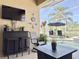 Relaxing outdoor covered seating area with bar, television, and ceiling fan at 408 Delwood Breck St, Ruskin, FL 33570