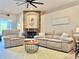 Comfortable living room with a stone fireplace, plush seating, and a bright, airy feel at 408 Delwood Breck St, Ruskin, FL 33570