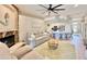 Inviting living space with a stone fireplace, comfortable seating, and a view of the kitchen at 408 Delwood Breck St, Ruskin, FL 33570